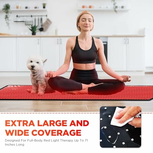 Woman meditating with a dog on a red light therapy mat in a kitchen.